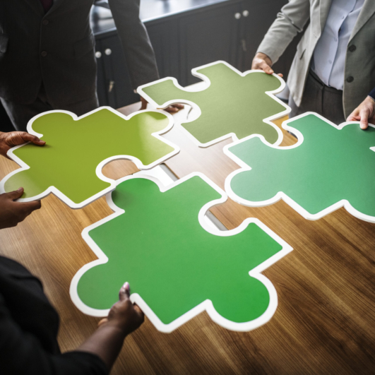 Business people connecting puzzle pieces